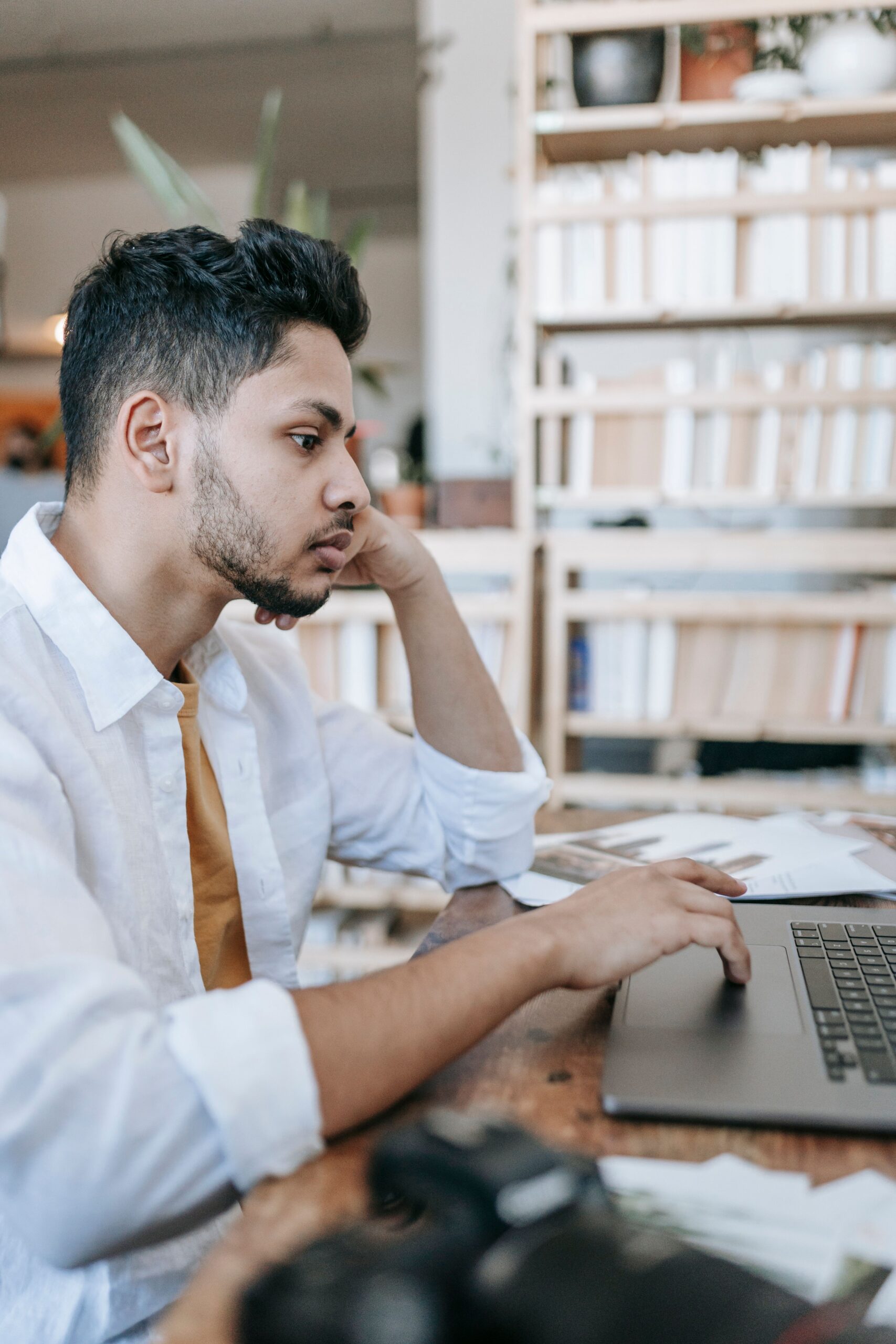 A young male job searching at a library