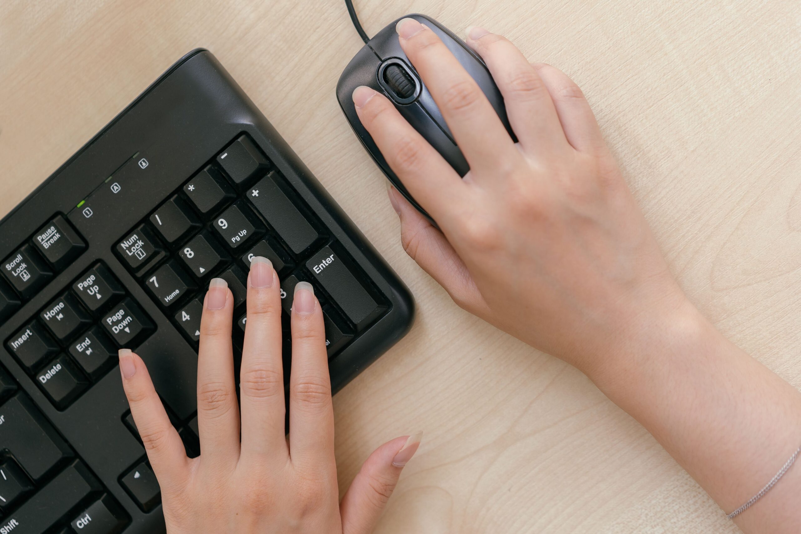 hands hovering over a mouse